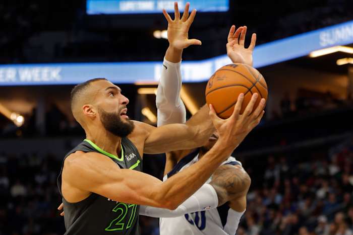Jan 31, 2024; Minneapolis, Minnesota, USA; Minnesota Timberwolves center Rudy Gobert (27) works around Dallas Mavericks center Richaun Holmes (20) in the fourth quarter at Target Center.